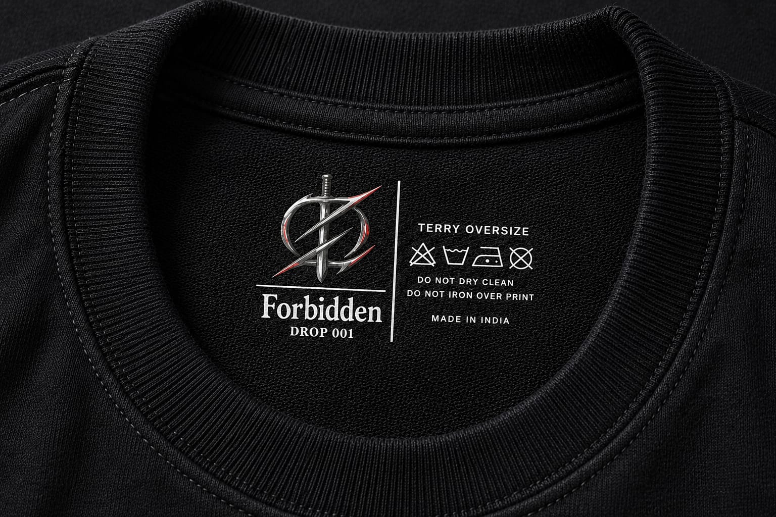 Close-up of a Zentoku Forbidden tee collar with its printed neck label and care symbols